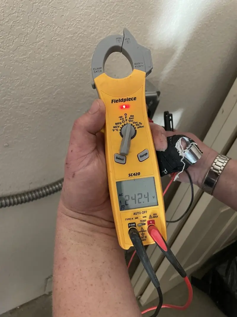 Voltage testing with clamp meter during Recessed Lighting Installation in Red Chute